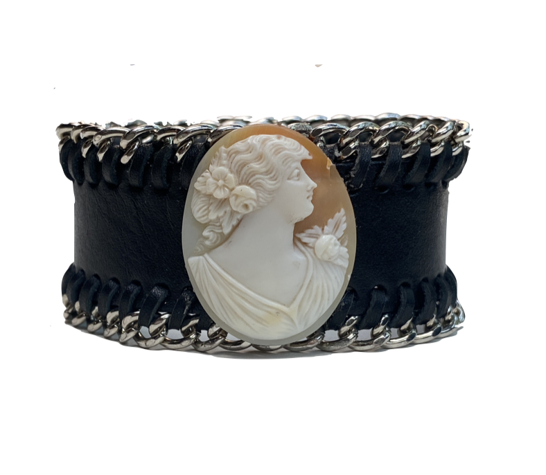 Black leather cuff laced with silver chain and set with a carved shell cameo.